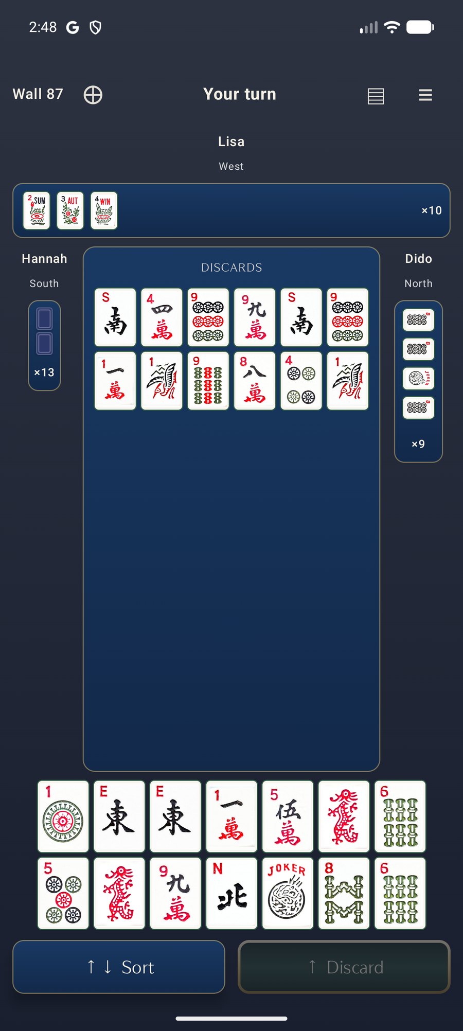 A mid-hand table on Android, midnight navy with the Original tile set, showing the discard floor and a full hand